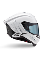 Casque Alpinestars Supertech R10 Solid, casque de moto racing blanc brillant et noir mat, vue de profil, design aérodynamique avec ailerons arrière et évents latéraux, visière teintée bleu, arborant un logo étoile Alpinestars noir sur le côté