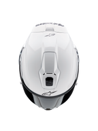 Casque Alpinestars Supertech R10 Solid, casque intégral de moto, blanc brillant, vue de dessus mettant en avant les aérations aérodynamiques et les logos Alpinestars noirs, profil épuré d'inspiration racing.
