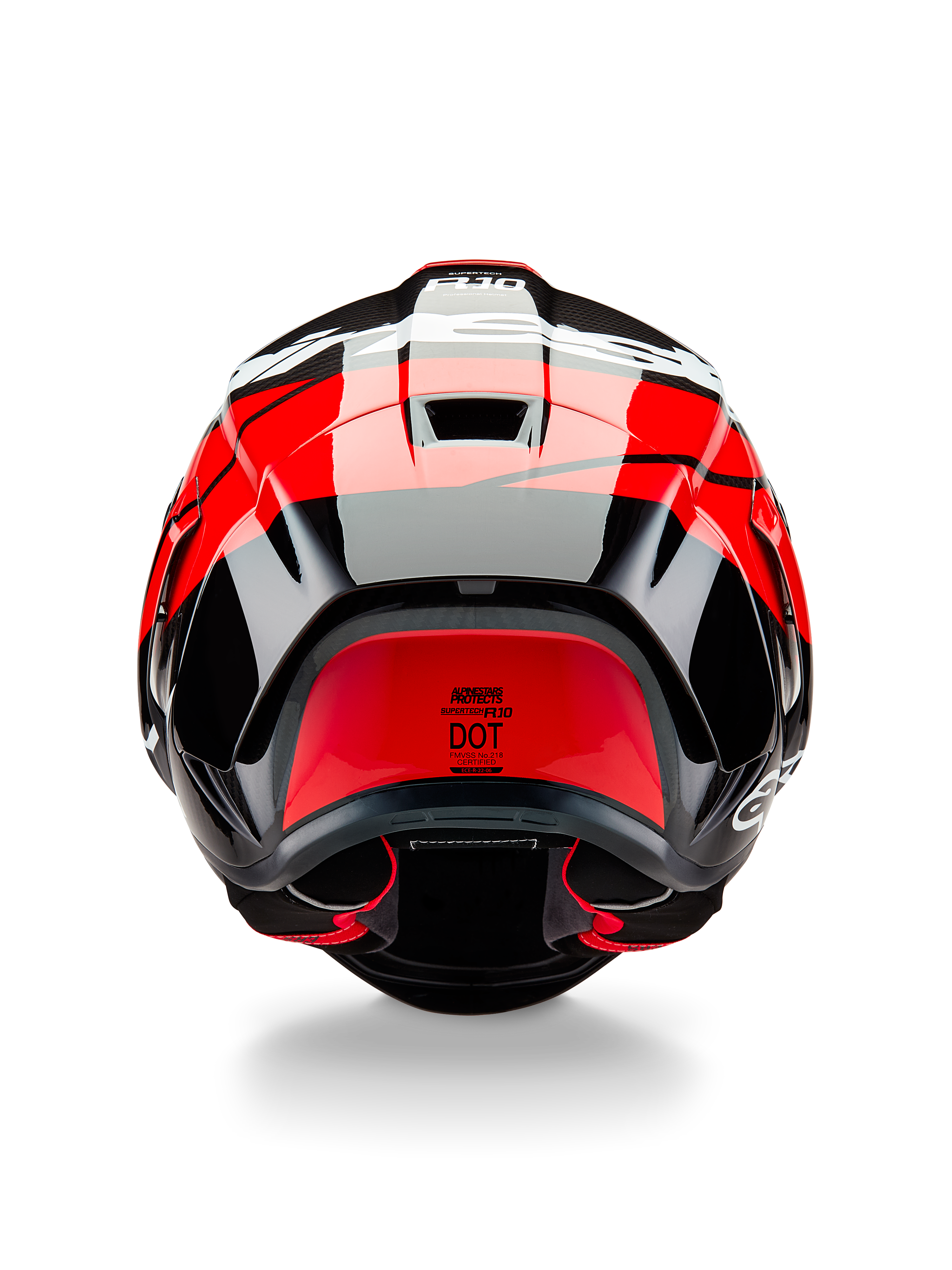 Casque Alpinestars Supertech R10 Element, vue arrière, carbone noir avec des accents rouge vif et blanc brillant, doté d'un aileron arrière aérodynamique, d'extracteurs d'air et de l'étiquette de certification DOT, design épuré inspiré de la course avec détails en fibre de carbone