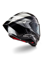 Casque Alpinestars Supertech R10 Element, Noir Carbone Argent Noir Brillant, vue de trois-quarts arrière montrant le profil aérodynamique de course, coque en fibre de carbone brillante avec motifs géométriques gris et noirs, logo Alpinestars et rembourrage intérieur rouge