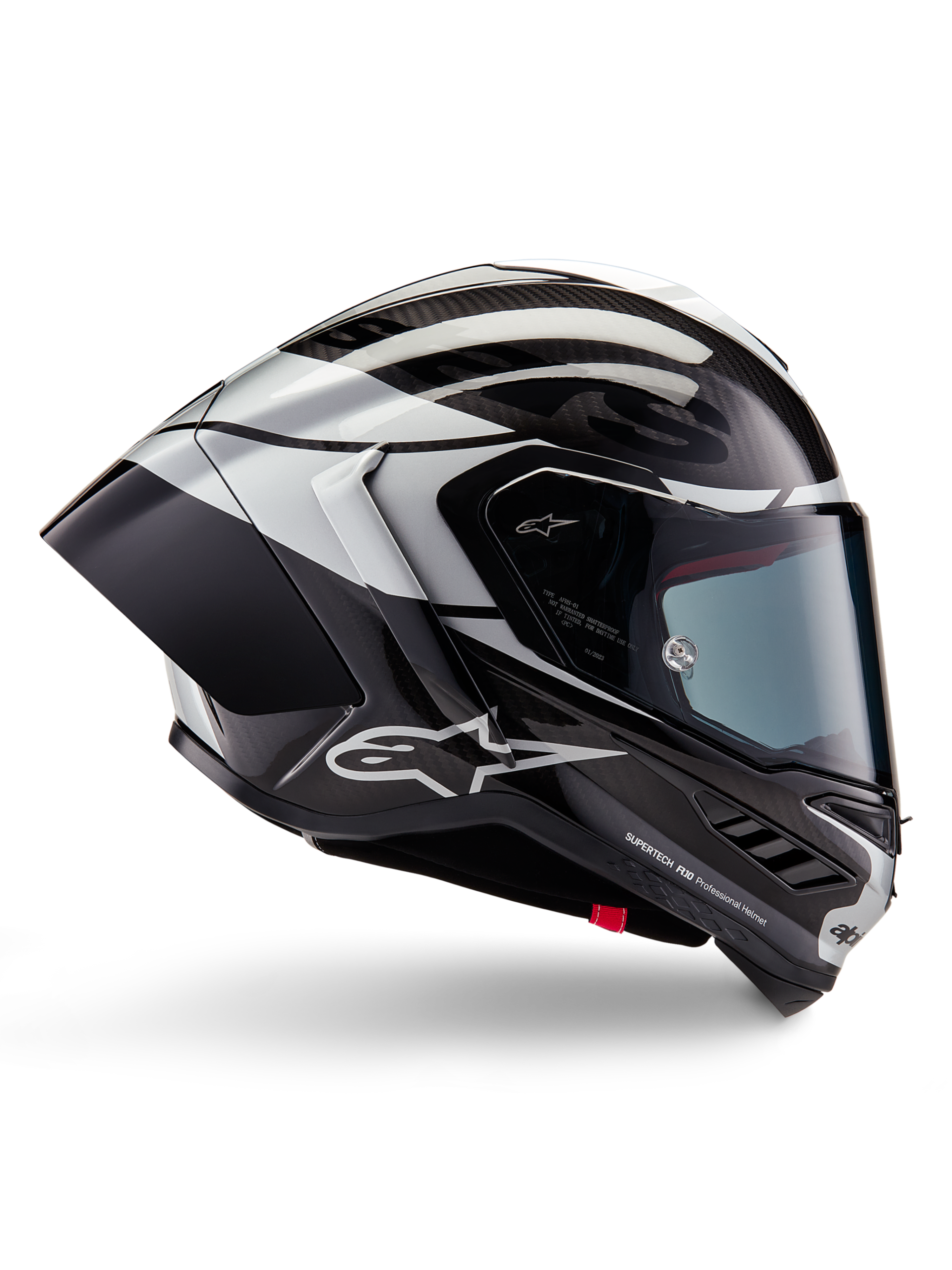 Casque Alpinestars Supertech R10 Element, casque intégral de course moto, finition carbone noir, argent et noir brillant, vue de profil avec coque aérodynamique en fibre de carbone, visière transparente et logo Alpinestars distinctif