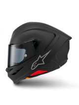 Casque Alpinestars S-R7 Solid, casque de moto intégral, noir mat, vue de profil, avec logo Astars argenté sur le côté, design aérodynamique avec spoiler intégré et ventilations de mentonnière, et accents rouges et orange à la base.