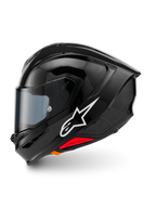 Casque Alpinestars S-R7 Solid, casque de moto intégral, noir brillant, vue de profil gauche présentant le logo Alpinestars blanc, coque aérodynamique avec spoiler intégré, visière teintée et accents rouges de libération d'urgence