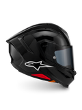 Casque Alpinestars S-R7 Solid, casque intégral de moto, noir brillant, vue de profil avec logo A-star blanc, coque aérodynamique profilée avec spoiler intégré et accents rouges à la base, conçu pour la course et les performances sportives.