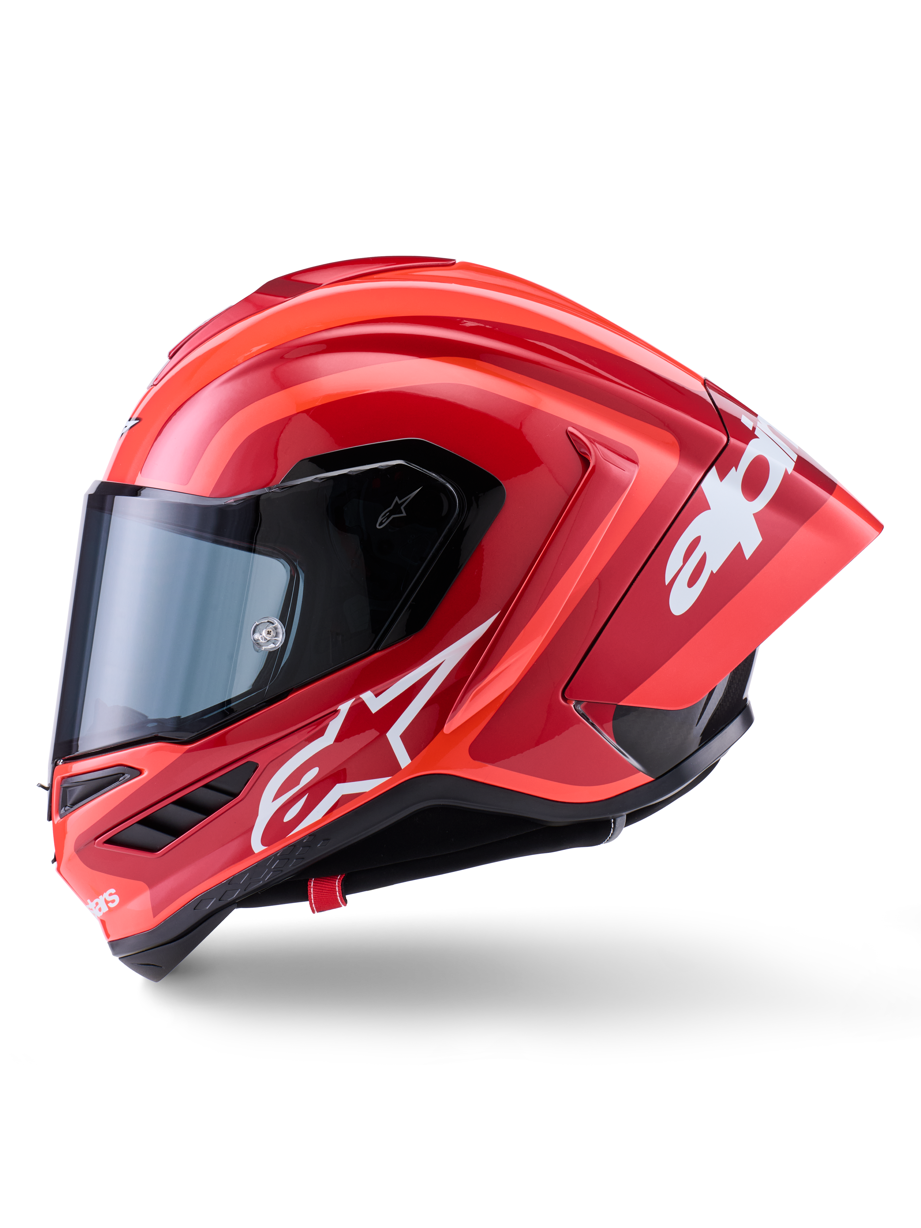 Casque Alpinestars Supertech R10 Arius, casque de course intégral, rouge brillant avec graphismes de logo blancs, vue de profil soulignant le spoiler aérodynamique et la visière transparente, coque en composite de fibre de carbone pour le sport motocycliste professionnel