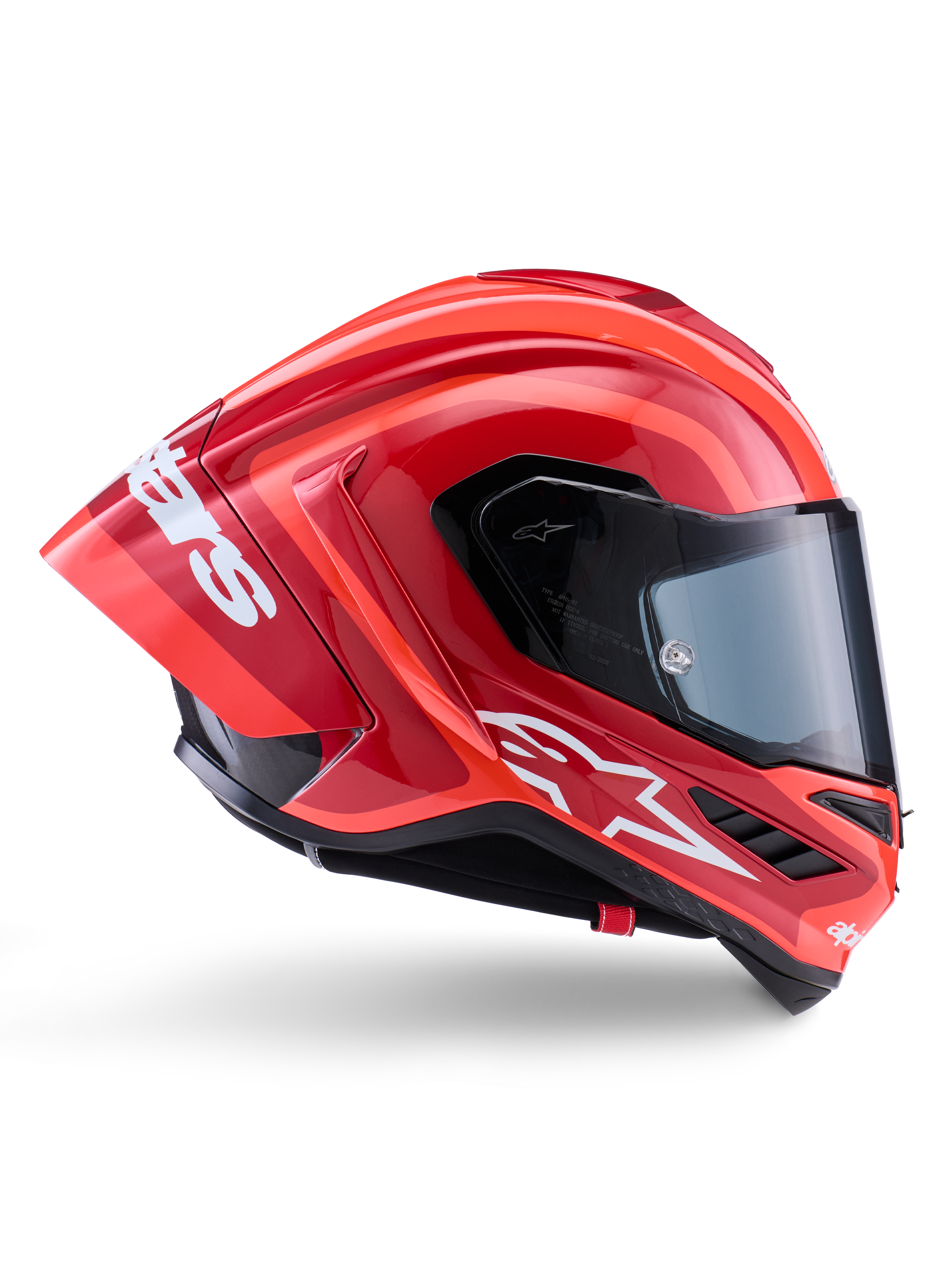 Casque Alpinestars Supertech R10 Arius, casque de course intégral, rouge et orange brillant, vue de profil présentant un spoiler arrière aérodynamique, logo Astars blanc sur la mentonnière et visière transparente, conçu pour la performance sur piste à haute vitesse