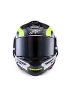 Casque Alpinestars Supertech R10 Arius, casque de moto de course, noir, argent et jaune fluo brillant, vue de face présentant une coque en fibre de carbone, une visière fumée foncée et un système de ventilation intégré.