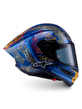 Casque Alpinestars Supertech R10 Martinator Thai en carbone bleu brillant, mandalas dorés complexes et profil de course.