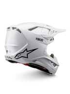 Casque Alpinestars Supertech M10 Solid ECE 22.06 de motocross, blanc brillant avec graphismes noirs, accents rouges, ouvertures de ventilation et visière pare-soleil