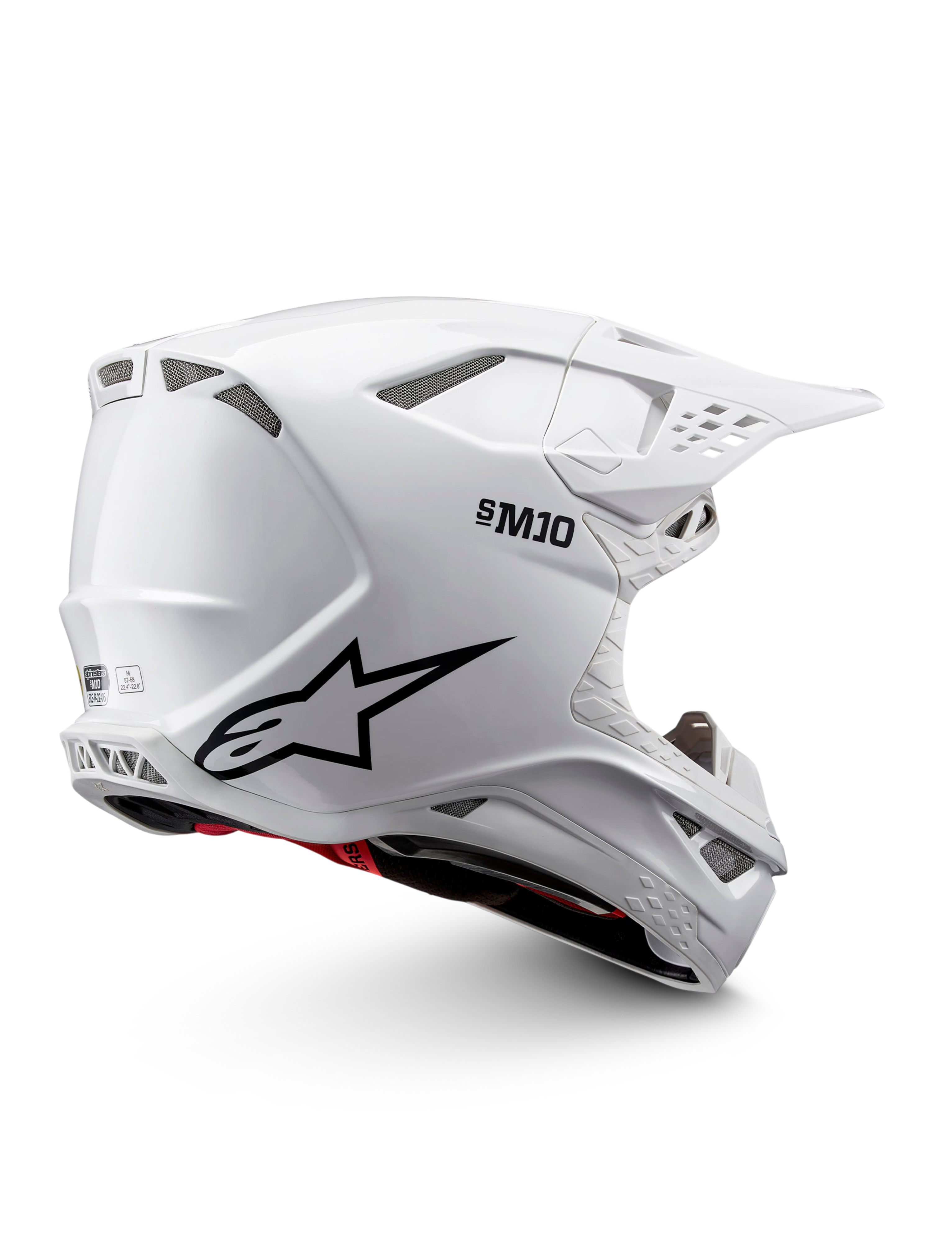 Casque Alpinestars Supertech M10 Solid ECE 22.06 de motocross, blanc brillant avec graphismes noirs, accents rouges, ouvertures de ventilation et visière pare-soleil