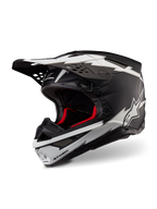 Alpinestars Supertech M10 Ampress Helmet, Motocross Helmet, Matte Black and White, featuring bold white lightning-style graphics and star logos, red internal lining, multi-composite carbon shell with a streamlined aerodynamic profile