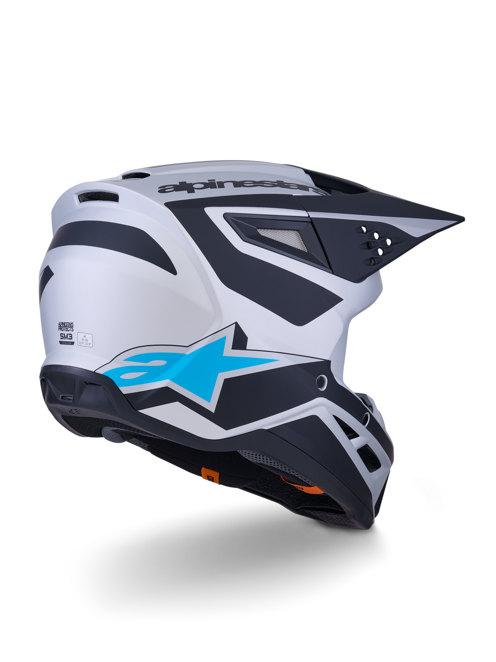 Alpinestars S-M3 Heat Helmet ECE 22.06, Motocross Helmet, Silver Blue and Black Matt, rear-view featuring large blue star logo and black angular designs, aerodynamic shell with ventilation ports, high-performance off-road racing protection