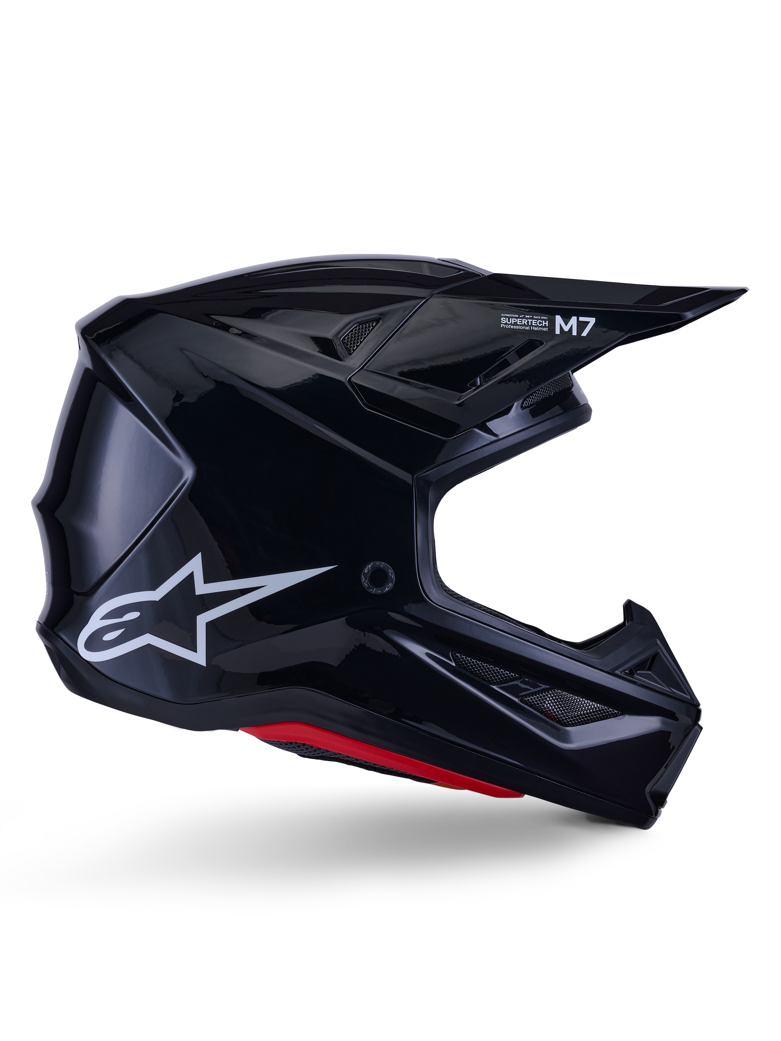 Alpinestars S-M7 Solid Helmet, Motocross Racing Helmet, Glossy Black with White Star Logo and Red Accents, side profile featuring aerodynamic design with angular mesh vents and Supertech M7 branding on the visor.