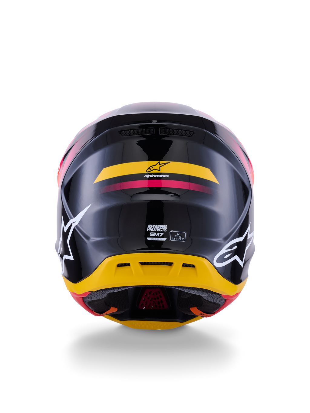 Casque Alpinestars S-M7 Rise ECE 22.06, casque de motocross, vue arrière, noir brillant avec des touches de jaune et de rose, grands logos blancs sur les côtés, coque composite aérodynamique, équipement de course tout-terrain
