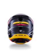 Casque Alpinestars S-M7 Rise ECE 22.06, casque de motocross, vue arrière, noir brillant avec des touches de jaune et de rose, grands logos blancs sur les côtés, coque composite aérodynamique, équipement de course tout-terrain