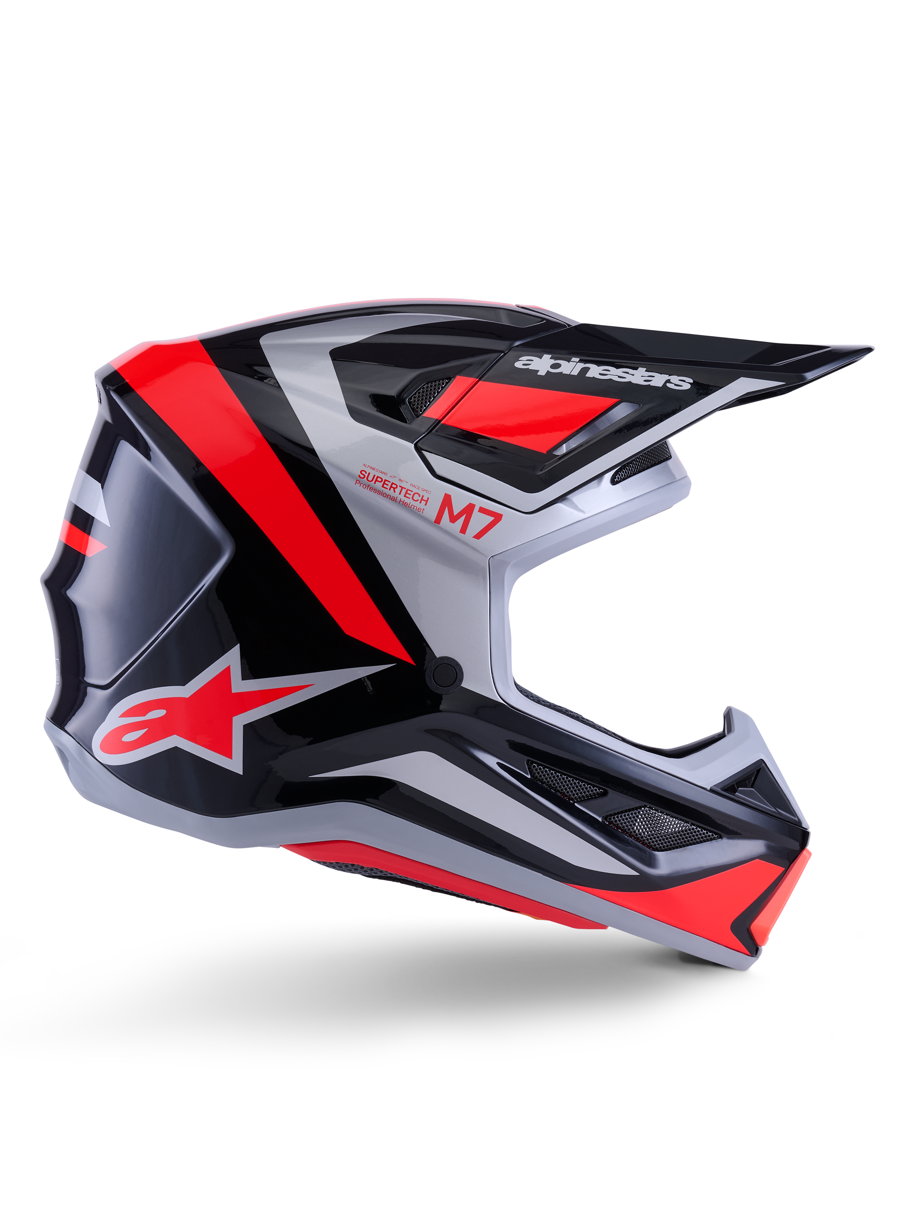 Casque Alpinestars S-M7 Rise, casque de motocross, noir, argent et rouge fluo, vue latérale montrant un design aérodynamique angulaire avec visière et aérations, finition brillante, série Supertech M7