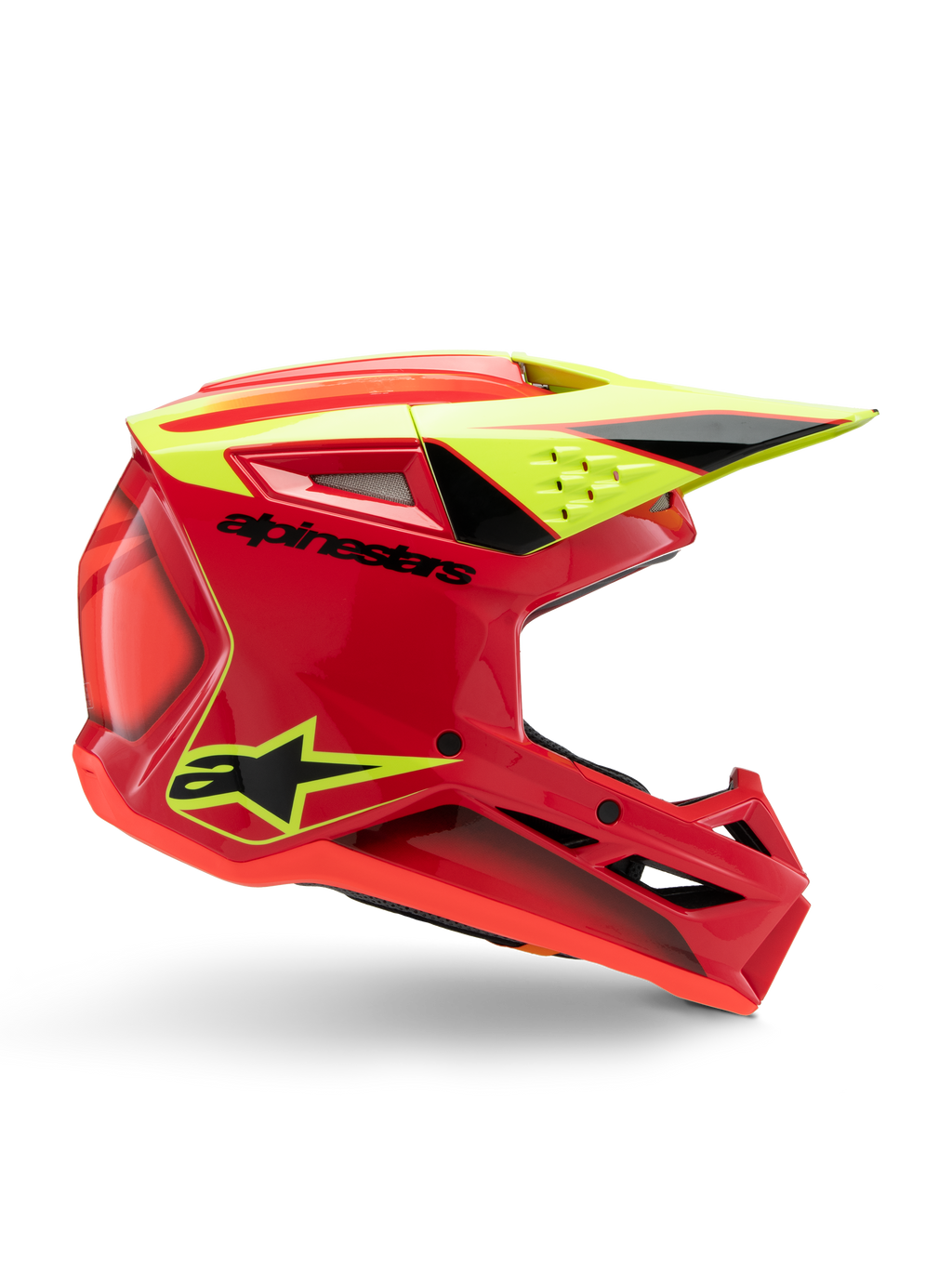 Casque Alpinestars S-M3 Youth Fray, casque de motocross, rouge, jaune fluo et noir brillant, vue de profil montrant un design aérodynamique élégant avec visière intégrée et aérations proéminentes, logo noir audacieux sur une coque rouge vif, optimisé pour les performances tout-terrain des jeunes pilotes