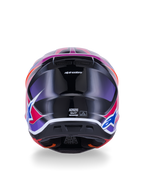 Casque Alpinestars S-M7 Fuse, casque de motocross, vue arrière, bleu, violet et rose brillant, graphismes rose et violet éclatants sur une coque noire brillante, avec ports de ventilation et étiquette de certification ECE 22.06