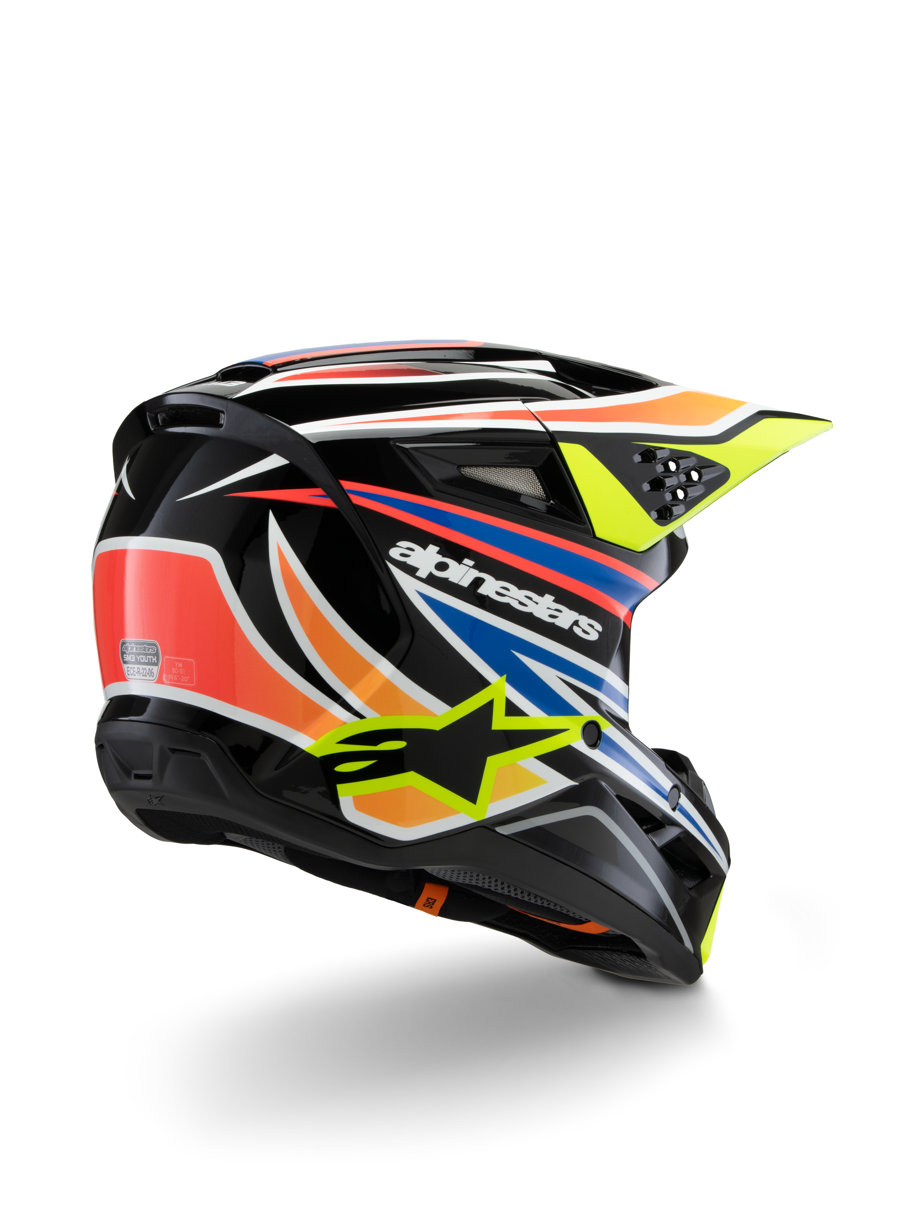 Casque Alpinestars S-M3 Youth Wurx, casque de motocross pour enfant, noir avec accents orange vif, rouge, bleu et jaune fluo, vue de trois-quarts arrière montrant la coque aérodynamique et les orifices de ventilation, finition brillante avec logo Alpinestars bien visible.