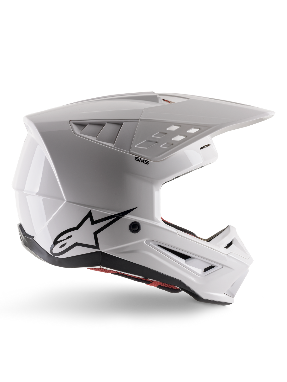 Alpinestars S-M5 Solid Helmet ECE 22.06, casque de motocross, blanc brillant, profil latéral présentant un design aérodynamique angulaire, visière proéminente, aérations intégrées, logo Astars noir à l'arrière et rembourrage intérieur rouge visible