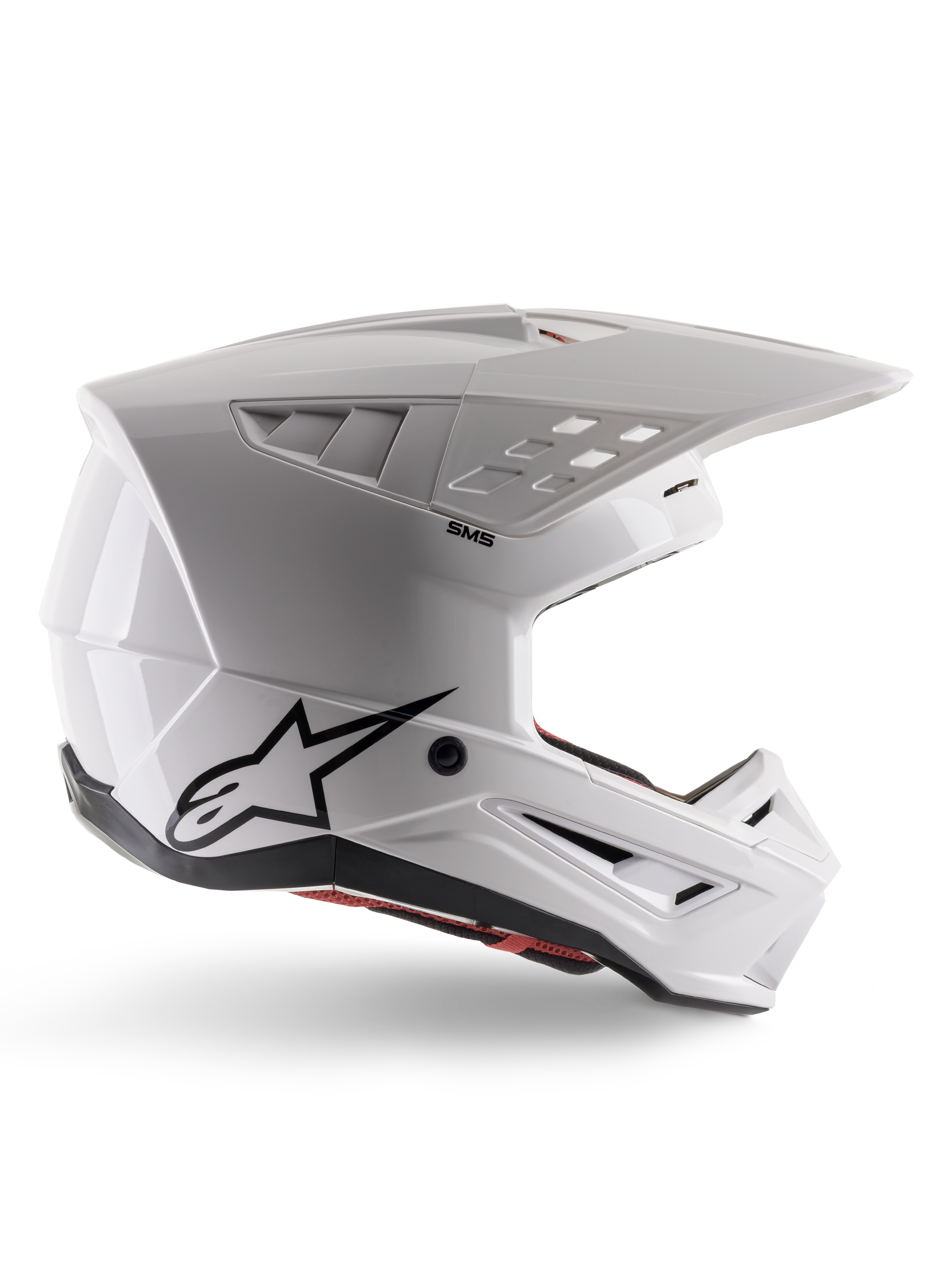 Alpinestars S-M5 Solid Helmet ECE 22.06, casque de motocross, blanc brillant, profil latéral présentant un design aérodynamique angulaire, visière proéminente, aérations intégrées, logo Astars noir à l'arrière et rembourrage intérieur rouge visible