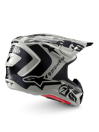 Alpinestars Limited Edition S-M7 Wolf Dust Helmet, Motocross Helmet, Dune Black Glossy, light gray shell with bold black Alpinestars graphics and Gothic-style text, streamlined aerodynamic design with multiple ventilation ports, red internal padding, high-performance off-road head protection