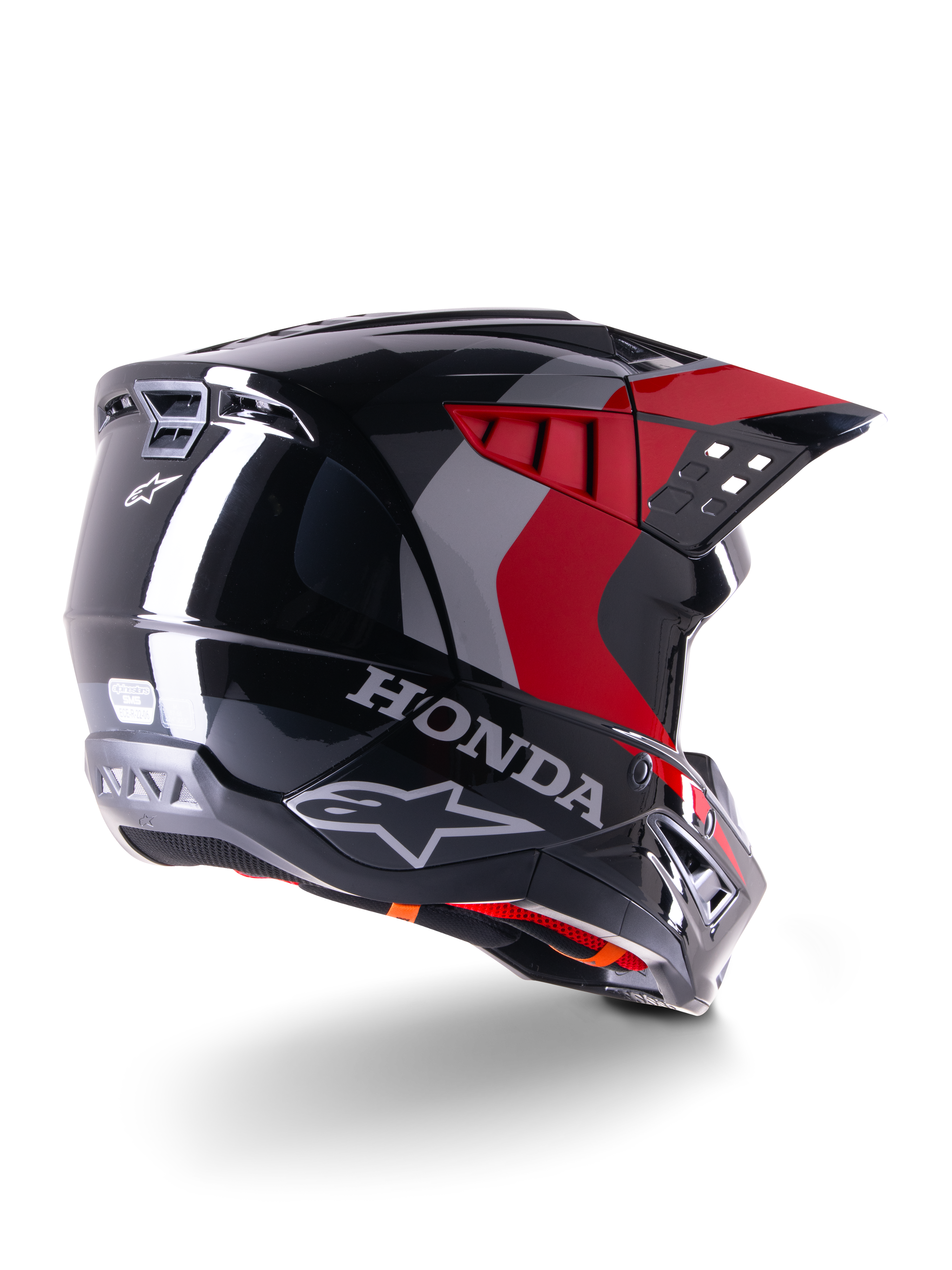 Casque Alpinestars Honda S-M5 ECE, casque de motocross, noir rouge brillant, vue de trois-quarts arrière avec marquage Honda et logos Alpinestars, finition brillante avec motifs graphiques rouges et gris, protection tout-terrain