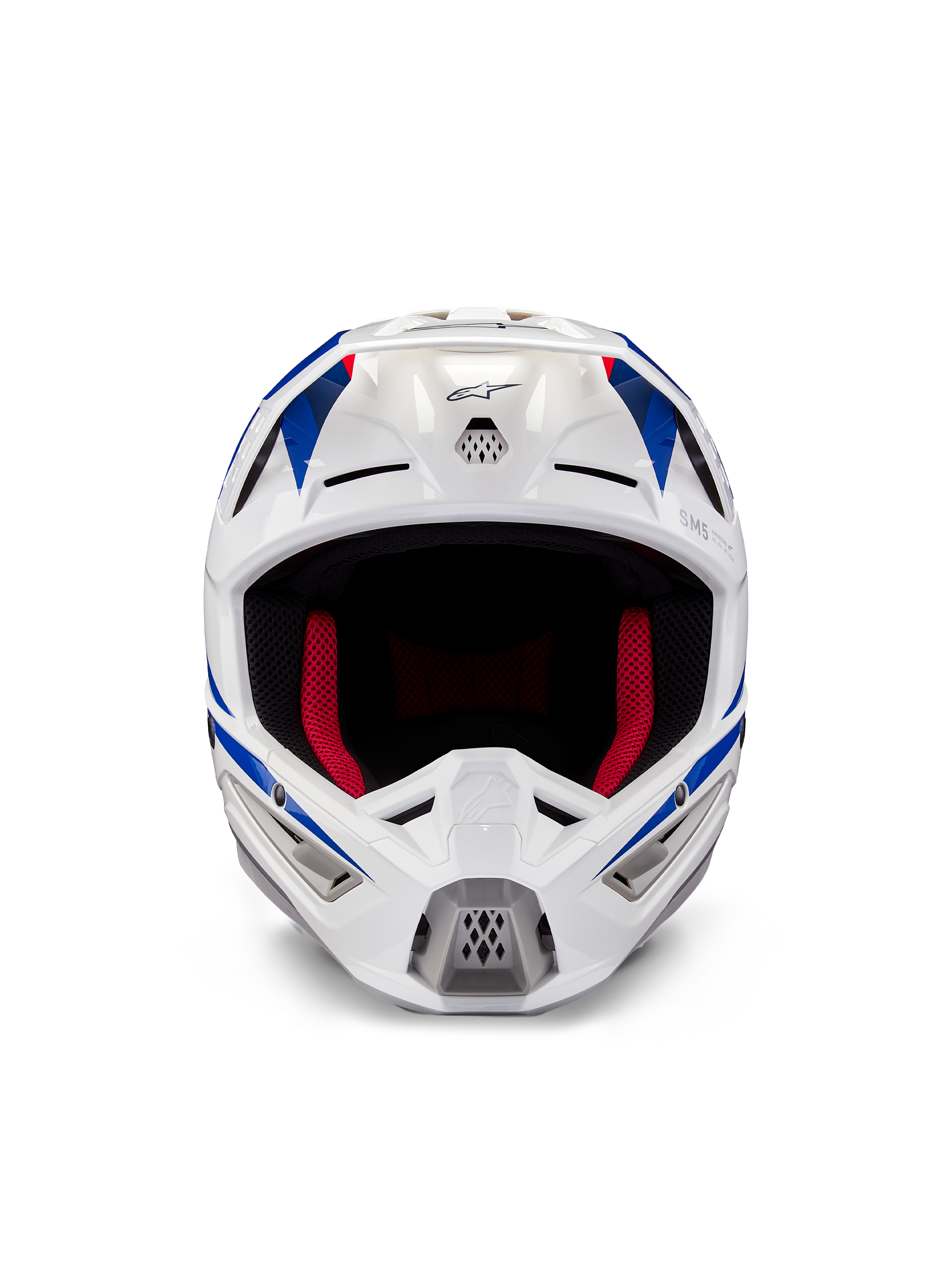 Casque Alpinestars Honda S-M5 ECE, casque de motocross, blanc, bleu et rouge brillant, vue de face montrant les ports de ventilation et le rembourrage intérieur rouge, design aérodynamique pour la protection en course tout-terrain
