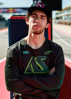 Alpinestars Ayess Csf Tee, Long Sleeve T-Shirt, Black, featuring green and yellow gradient AS graphics on the chest and sleeves, casual motorsport-inspired streetwear worn at a racetrack
