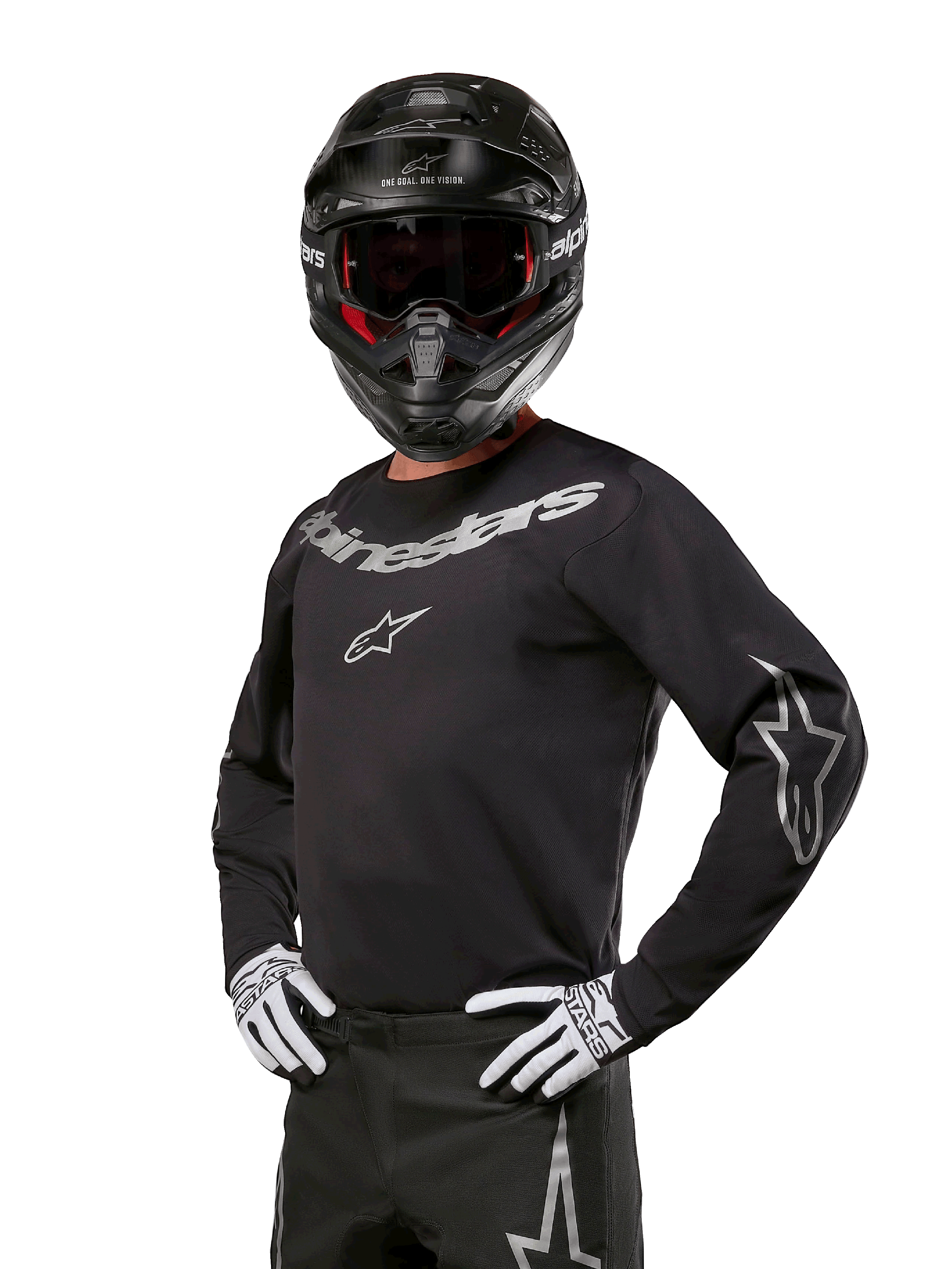 Alpinestars 2024 Fluid Graphite Jersey, Black and Silver Motocross Jersey, long-sleeve performance fit, worn with a black helmet and white gloves, featuring silver Alpinestars branding, off-road racing gear