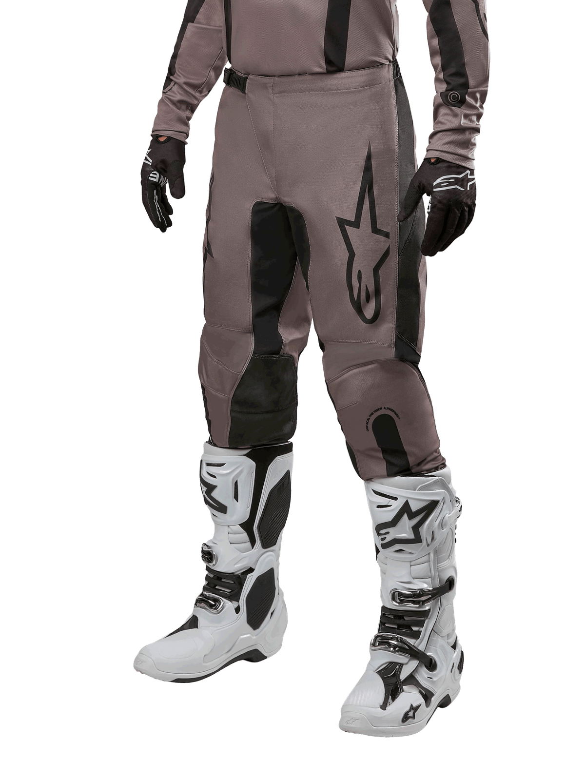 Alpinestars 2024 Fluid Lurv Pants, Motocross Pants, Mud Black and Black, featuring Alpinestars logo, worn with black gloves and white motocross boots, sporty design for off-road racing