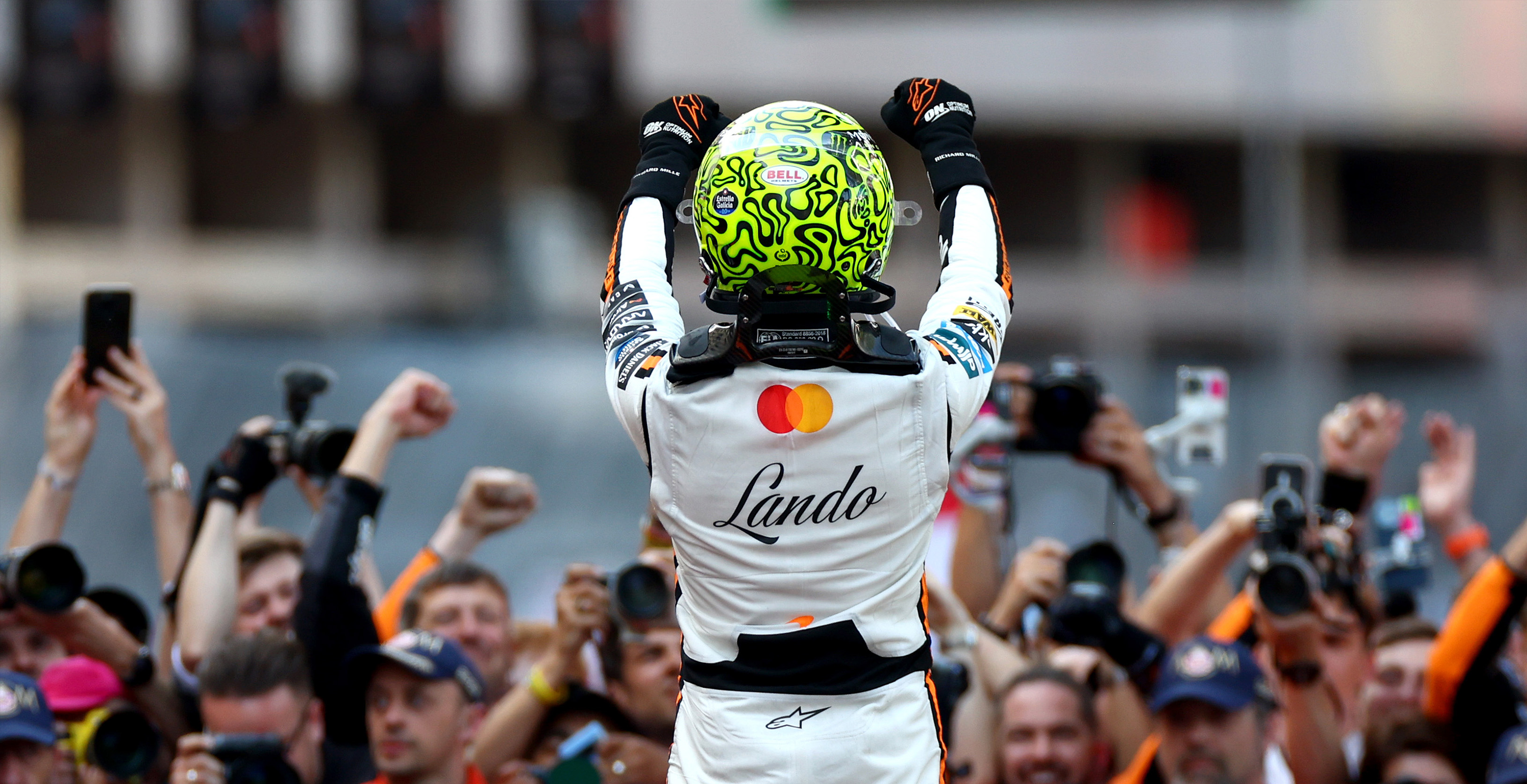 Lando Norris facing back celebrating a victory