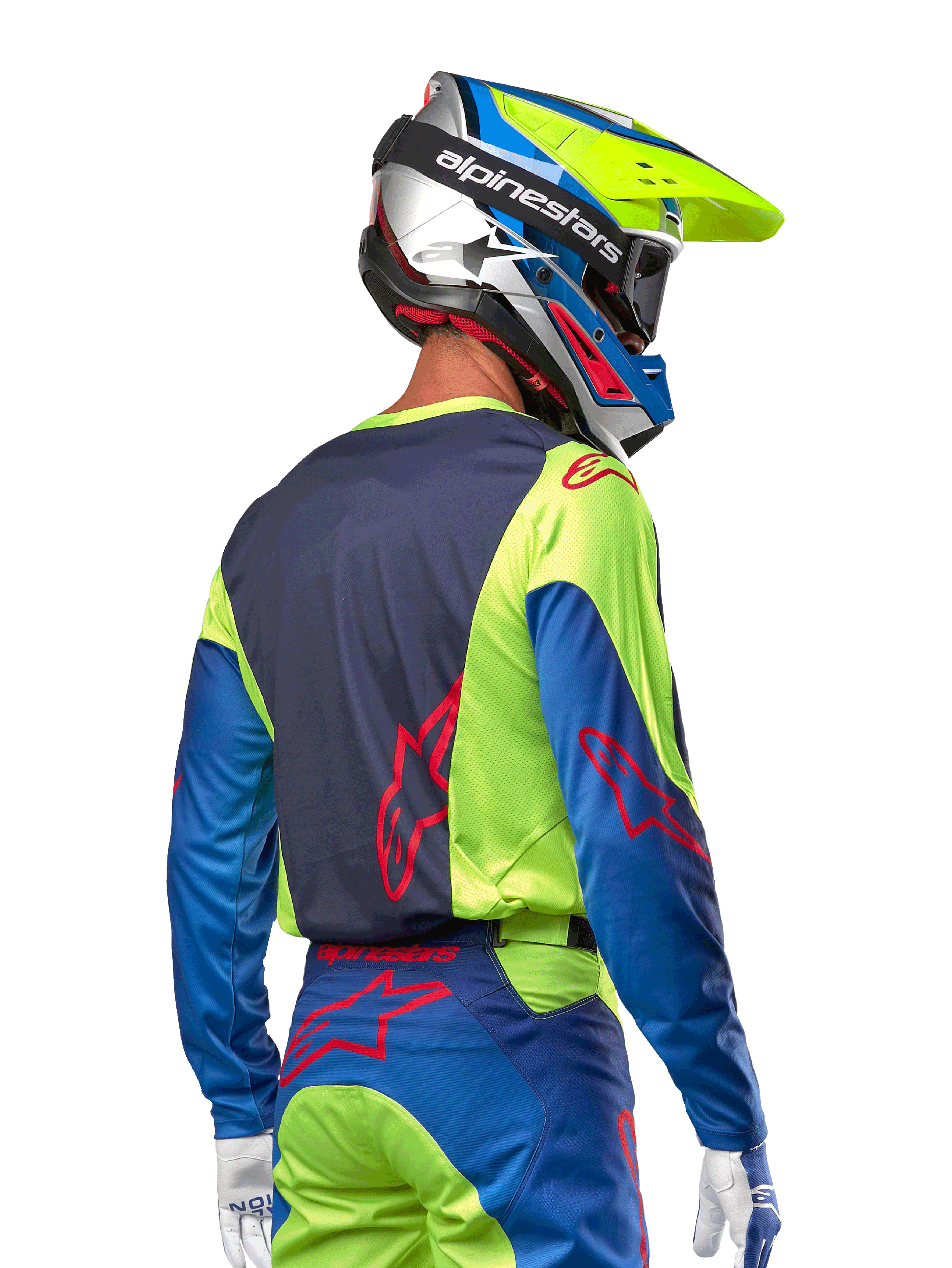 Motocross rider wearing the Alpinestars 2024 Racer Hoen Jersey in Yellow Fluo and Blue Night Navy, featuring a red star logo on the back, matching motocross pants, and a coordinated racing helmet, back view showcasing the ergonomic design for off-road performance.