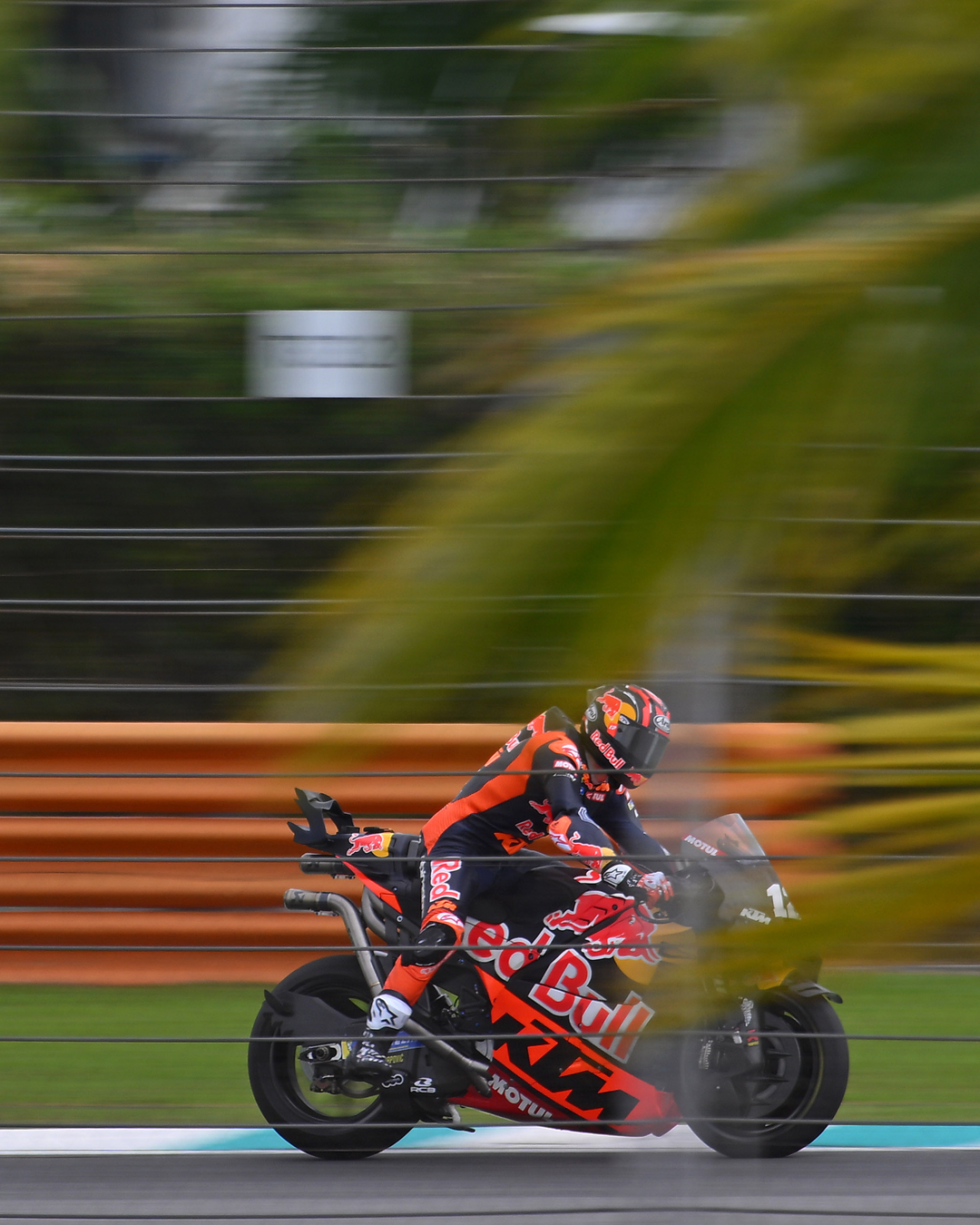 Maverick Vinales in action on a track with blurred background, wearing Alpinestars gear