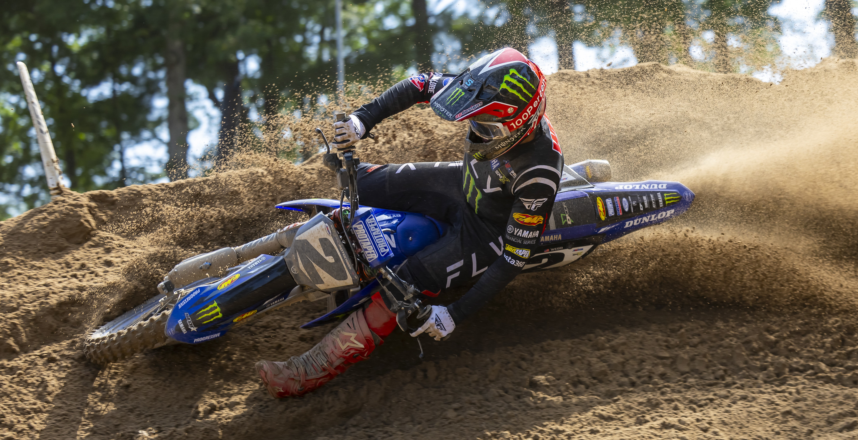 Cooper Webb in action on a dirt track with a Monster Energy Yamaha bike.