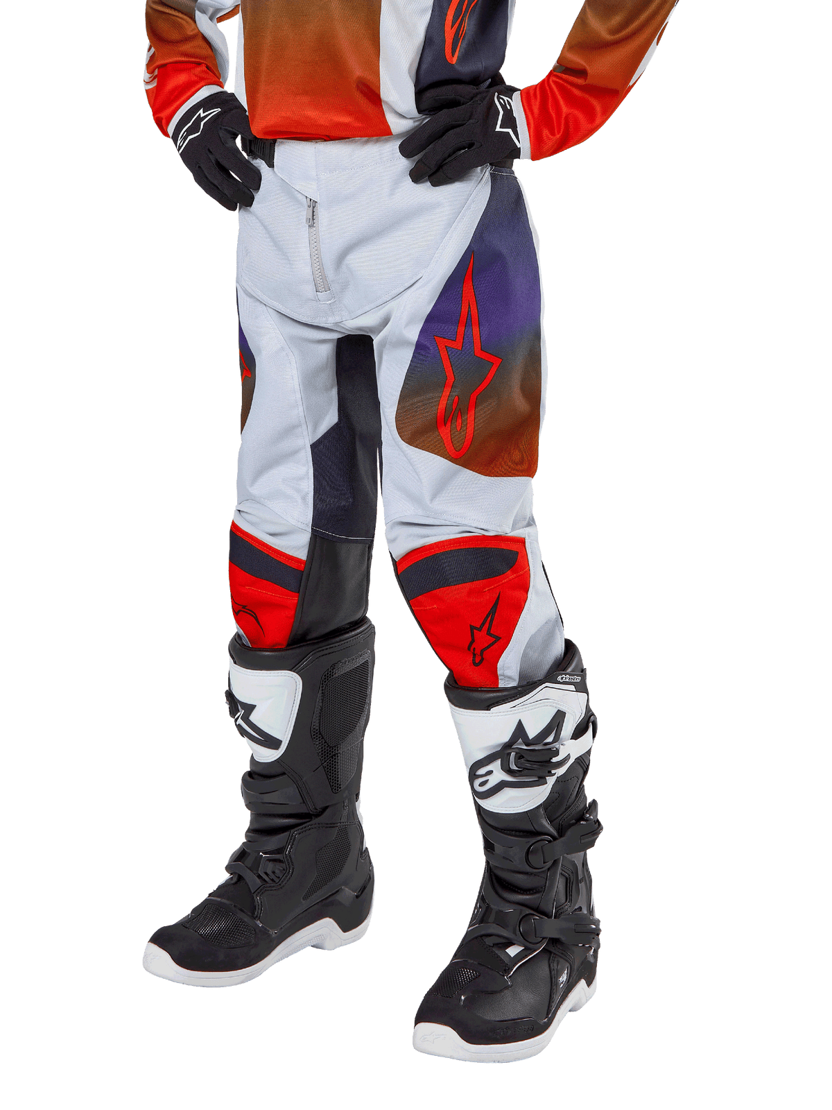 Alpinestars Pantalon Racer Hoen Junior 2024, pantalon de motocross, gris clair avec accents orange vif et noirs, avec logos étoiles rouges sur les cuisses et panneaux rouges aux genoux, porté avec des bottes noires et blanches, conception durable pour le tout-terrain