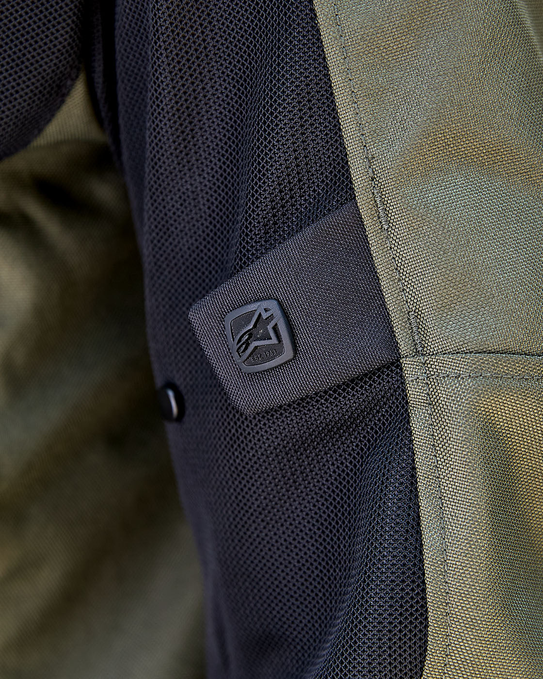 Alpinestars C-1 Air Motorcycle Jacket close-up featuring khaki and black breathable tech mesh with logo detail.