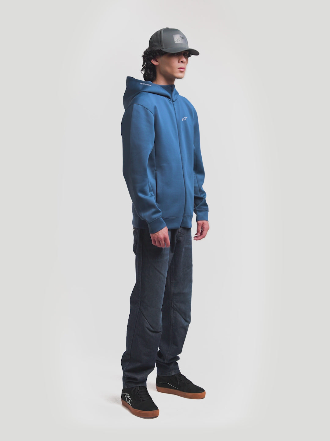 Alpinestars Algo Perf Adjustable Hat, Dark Grey Sportswear Snapback Cap, Unisex, featuring breathable side perforations and tech fabric construction. On-model view showing the structured crown, curved bill, and sonic-weld Astars logo heat stamp, perfect for everyday motorsports-inspired style.