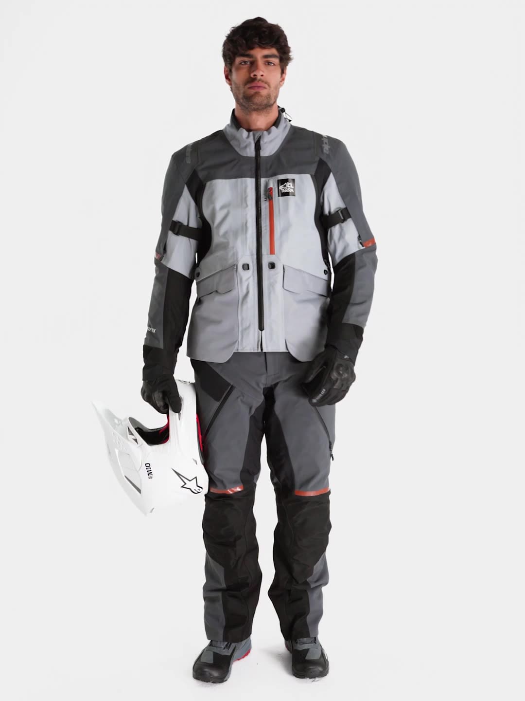 Alpinestars ST-7 V2 GORE-TEX® Jacket, men's adventure touring motorcycle jacket in mid gray, deep gray, and black, featuring waterproof textile construction, direct ventilation, and certified protection worn by a model.