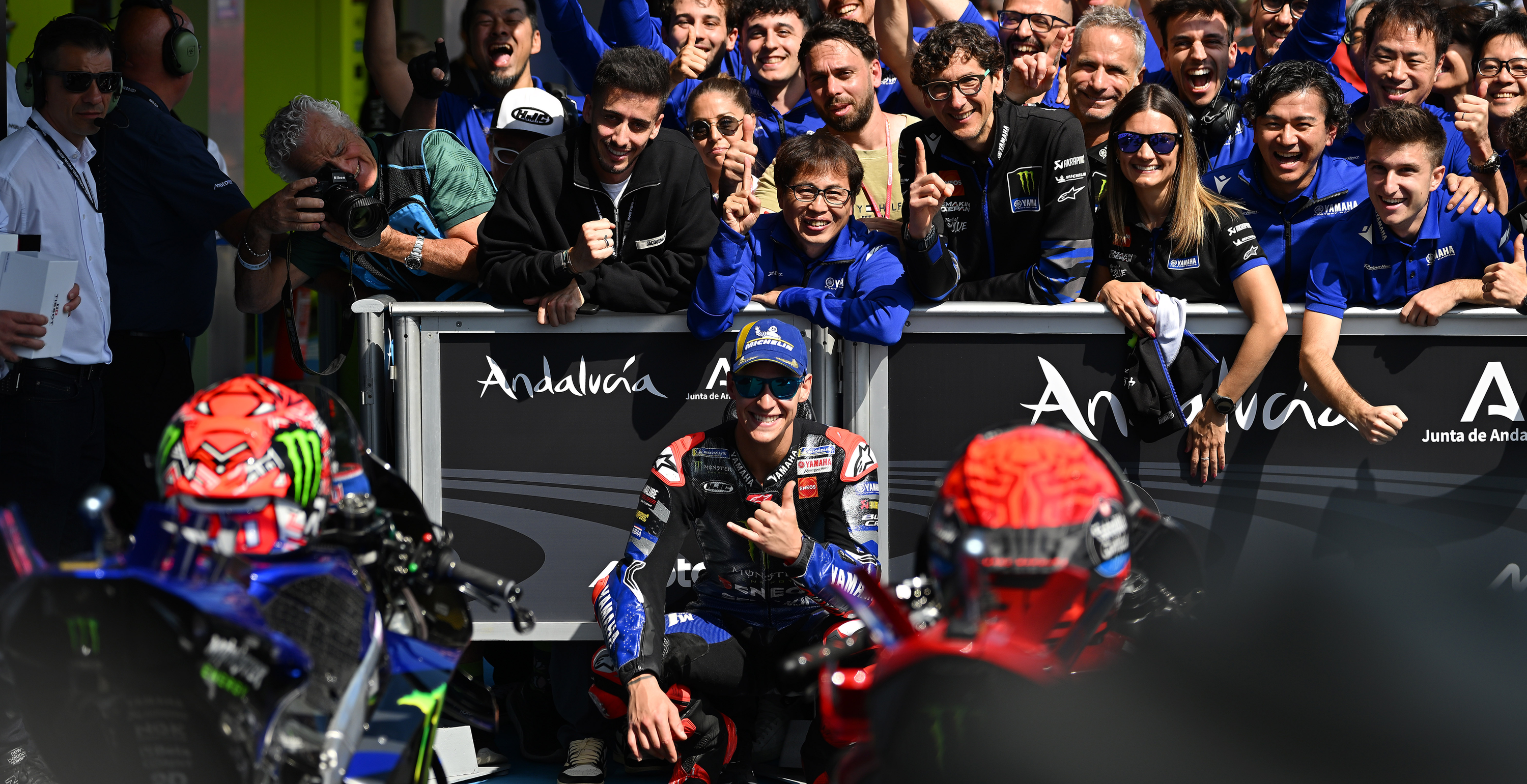Fabio Quartararo taking a selfie with the team and fans