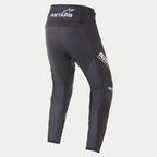 Pantalon Alpinestars Techstar Phantom 2021, pantalon de motocross, noir et blanc, vue arrière présentant le logo ASTARS blanc sur la taille et la cuisse, panneaux en mesh texturé anthracite sur les jambes, design de coupe performance pour la course.